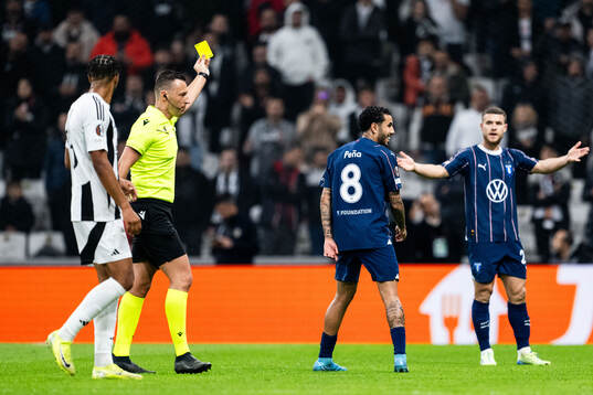 Sergio Pena of Malmö FF receives a yellow card from