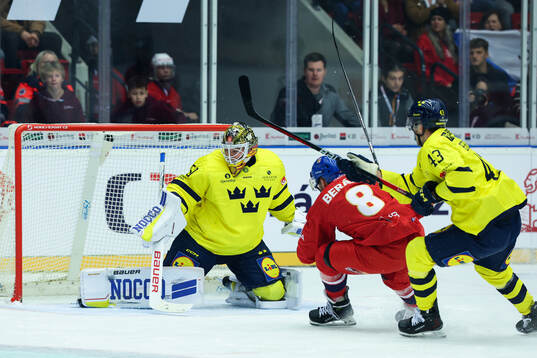 Goaltender Erik Källgren and Filip Berglund of Sweden