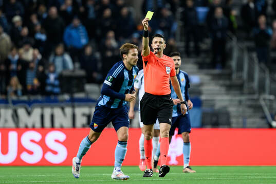 Daniel Stensson of Djurgården receives a yellow card from