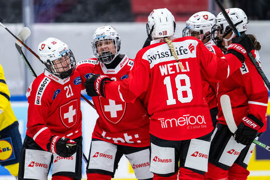 Rahel Enzler of Switzerland celebrates with team mates