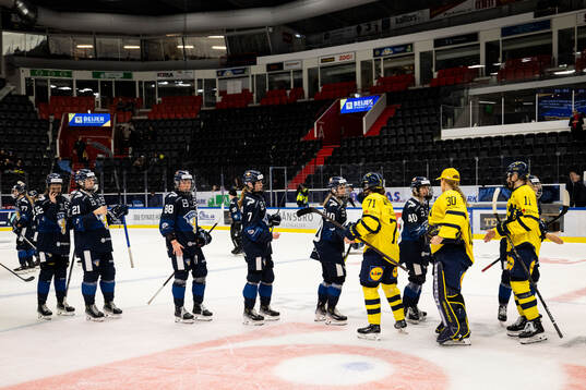 Players from Sweden and of Finland embrace