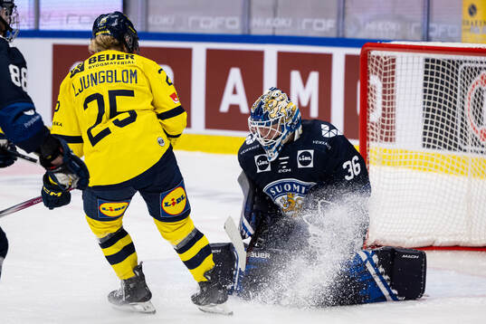 Lina Ljungblom of Sweden and goaltender Anni Keisala of