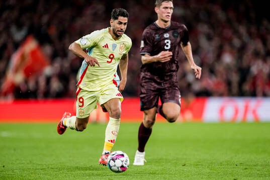 Ayoze Perez of Spain and Jannik Vestergaard of Denmark