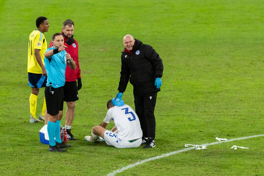 Denis Vavro of Slovakia receives medical care