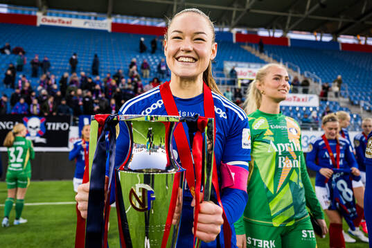 Janni Thomsen of Vålerenga celebrates with the trophy