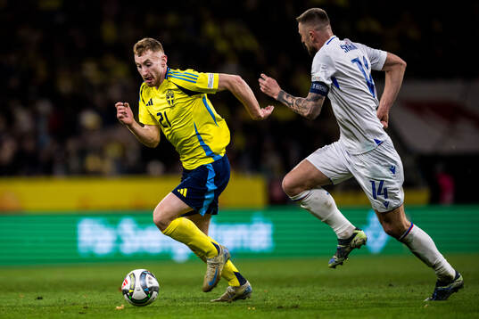 Dejan Kulusevski of Sweden and Milan Skriniar of Slovakia