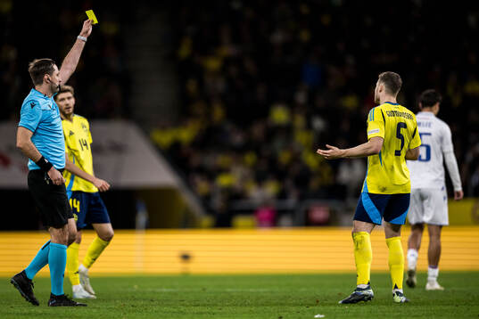 Gabriel Gudmundsson of Sweden revives a yellow card