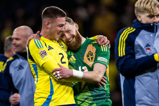 Emil Holm and goalkeeper Viktor Johansson of Sweden