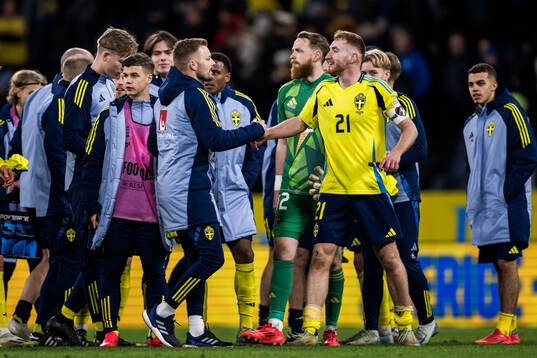 Assistant coach Sebastian Larsson and Dejan Kulusevski of