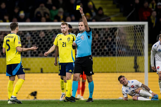 Gabriel Gudmundsson of Sweden receives a yellow card