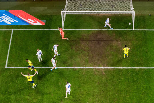 Alexander Isak of Sweden scores 2-1 behind goalkeeper