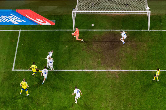 Alexander Isak of Sweden scores 2-1 behind goalkeeper