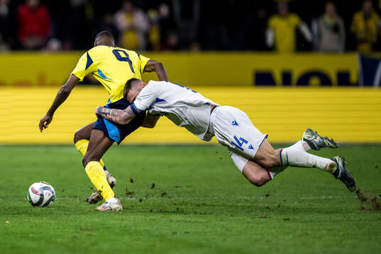 Milan Skriniar of Slovakia and Alexander Isak of Sweden