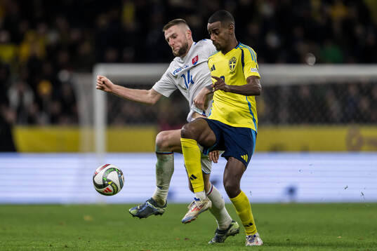 Milan Skriniar of Slovakia and Alexander Isak of Sweden