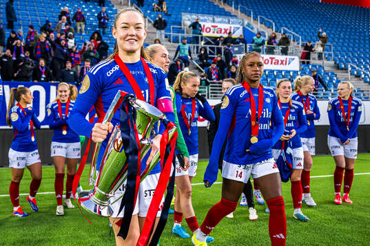 Janni Thomsen of Vålerenga celebrates with the trophy
