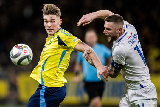 Viktor Gyökeres of Sweden and Milan Skriniar of Slovakia