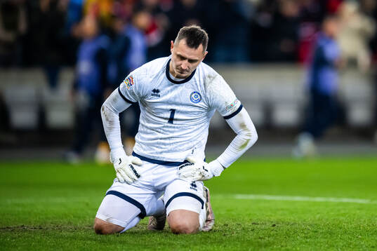 Goalkeeper Stas Pokatilov of Kazakhstan looks dejected