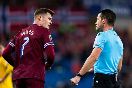 Alexander Sørloth of Norway and Jasper Vergoote, referee
