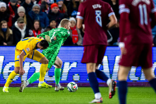 Aibar Zhaksylykov of Kazakhstan and goalkeeper Egil Selvik