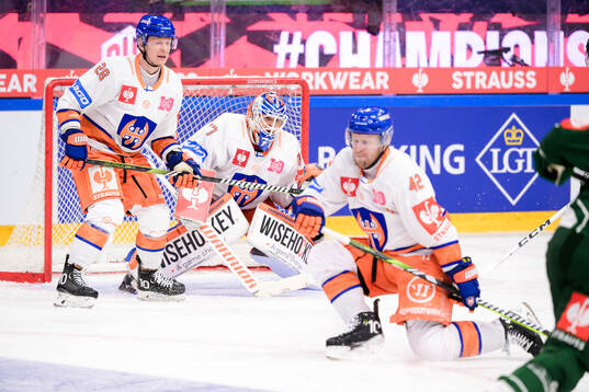 Otto Leskinen and goaltender Juha Metsola of Tappara Tampere