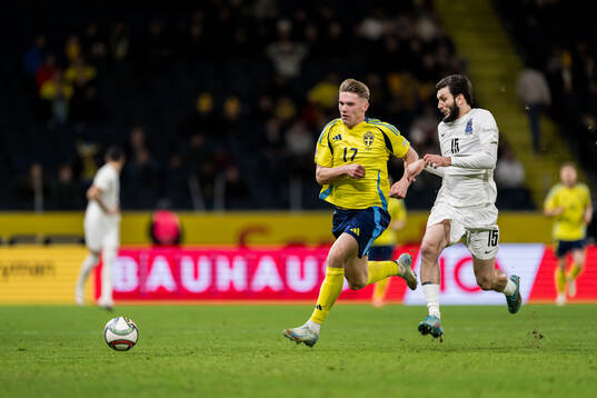 Viktor Gyökeres of Sweden and Hojjat Haghverdi of