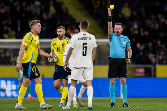 Joshgun Diniyev of Azerbaijan receives a yellow card from