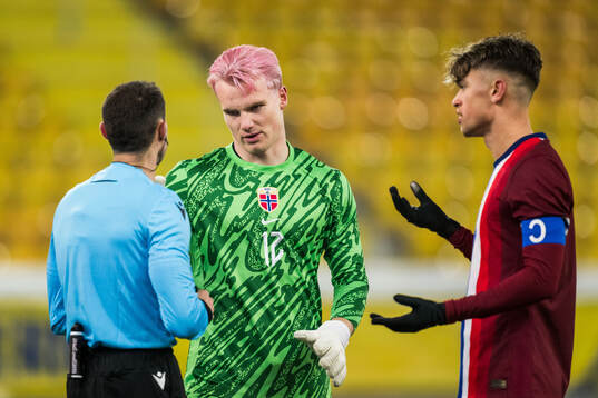 Referee David Fuxman and Goalkeeper Magnus Stær-Jensen and