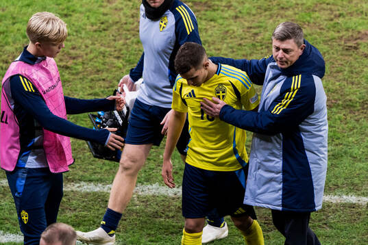 Yasin Ayari of Sweden leaves the pitch injured