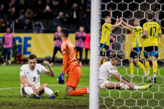 Joshgun Diniyev and goalkeeper Elvin Jafarguliyev of