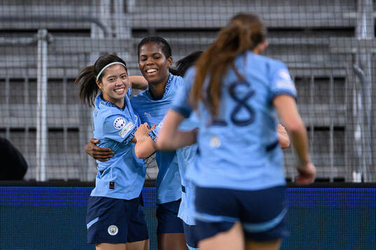 Yui Hasegawa and Khadija Shaw of Manchester City celebrate