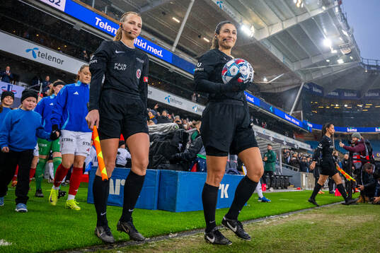 Referees Victoria Nilsen and Sarah Fatemeh Zangeneh enter