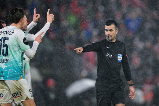 Referee Rohit Saggi gives a penalty