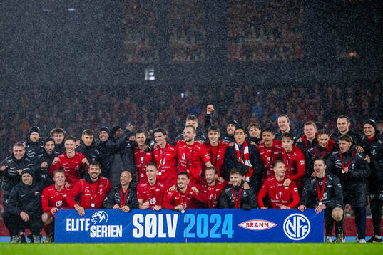 Players and staff of Brann celebrate