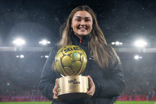 Anna Aahjem of Brann poses with the award as the top scorer