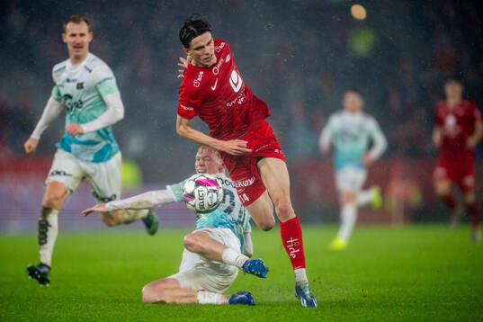 Vetle Auklend of Viking tackles Ulrik Mathisen of Brann to