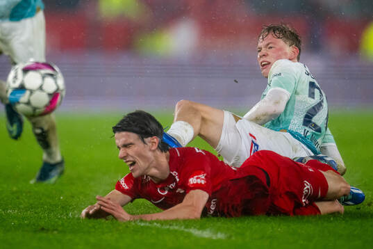 Vetle Auklend of Viking tackles Ulrik Mathisen of Brann to