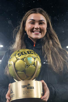 Anna Aahjem of Brann poses with the award as the top scorer