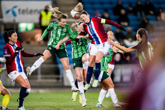 Simone Magill of Northern Ireland and Maren Mjelde of Norway