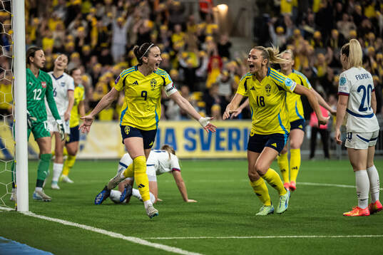 Kosovare Asllani and Fridolina Rolfö of Sweden celebrate