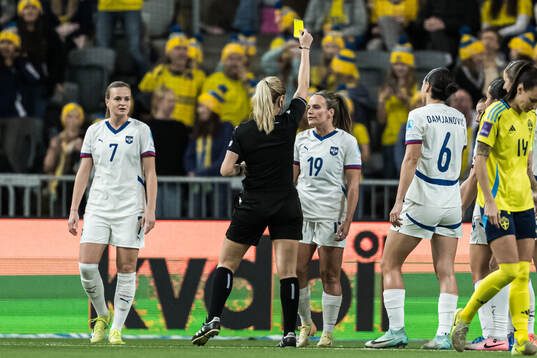 Referee Eleni Antoniou and Tyla Jay Vlajnic of Serbia