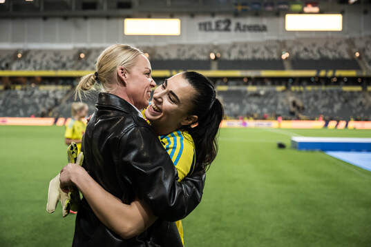 Caroline Seger and goalkeeper Zecira Musovic of Sweden
