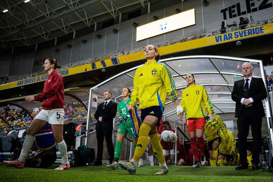 Kosovare Asllani and goalkeeper Zecira Musovic of Sweden