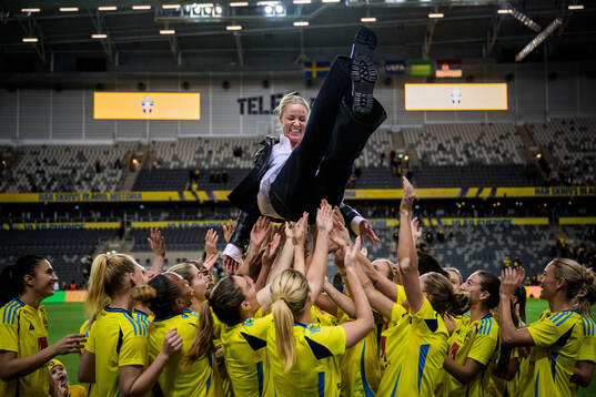 Players of Sweden throw Caroline Seger in the air