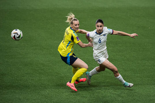 Stina Blackstenius of Sweden and Nevena Damjanovic of Serbia