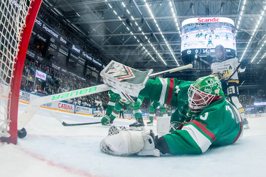Rögles målvakt Arvid Holm räddar ett skott från HV71s