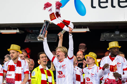 Daniel Fritz Eid of Fredrikstad celebrates with the trophy