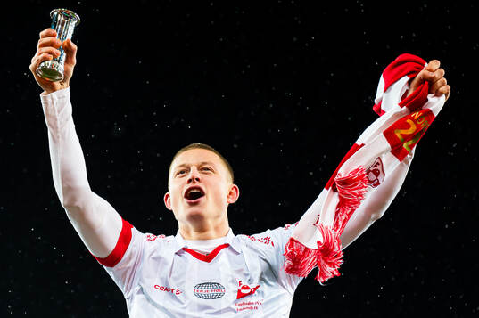 Brage Skaret of Fredrikstad celebrates with the trophy