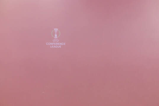 The logotype of UEFA Conference League is visible through