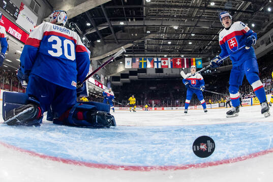 Goaltender Samuel Urban and Samuel Barcik of Slovakia look