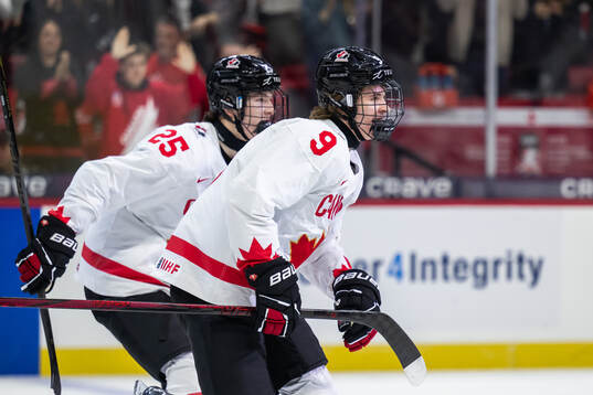 Gavin McKenna of Canada celebrates